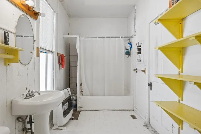 a bathroom with a sink a mirror and a bathtub