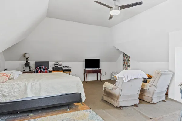 a bedroom with a bed and a couch