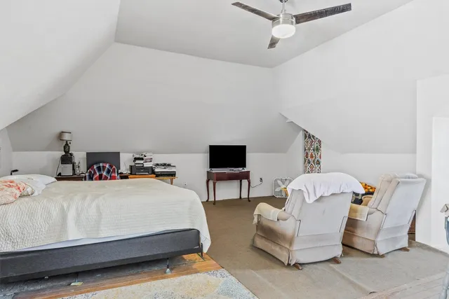 a bedroom with a bed and a couch