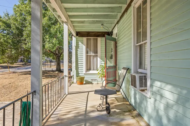 a living room with large windows and furniture