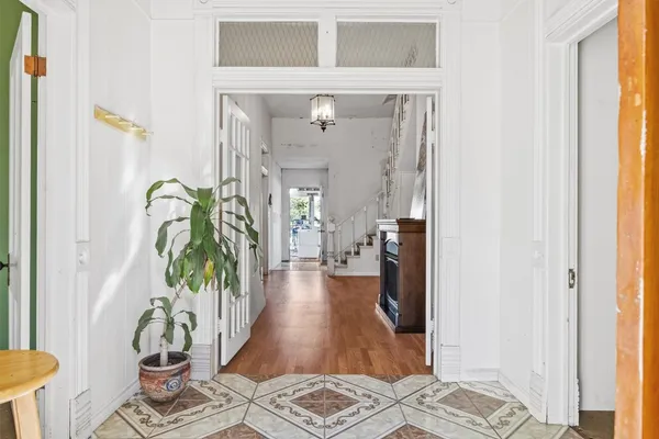 a living room with furniture and a potted plant