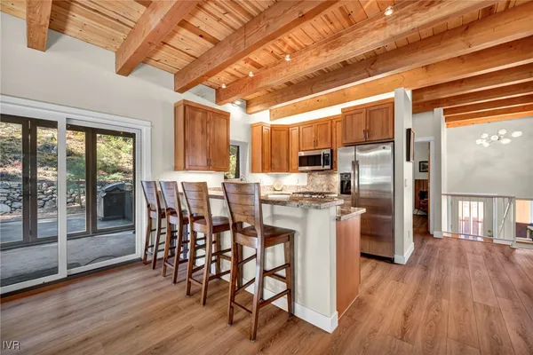 a dining room with furniture and wooden floor