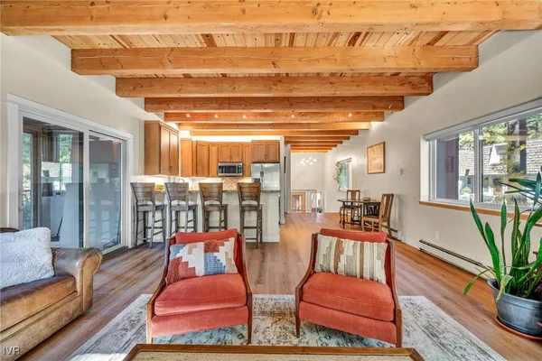a living room with furniture and a floor to ceiling window