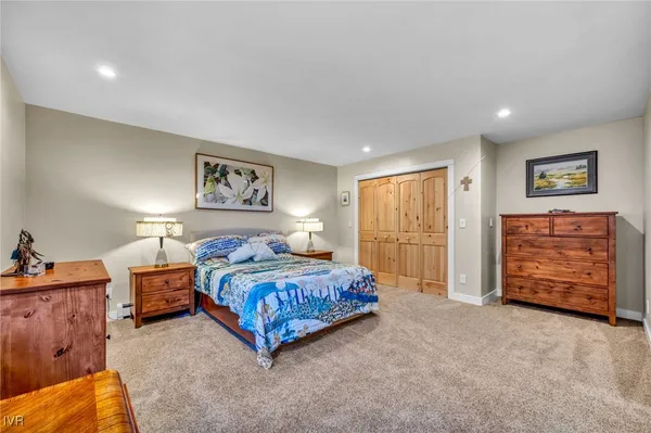 a bedroom with a large bed and a closet