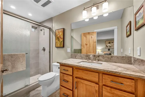 a bathroom with a sink a toilet and mirror