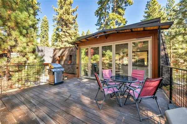 a view of a chairs and fire pit in the back yard of the house