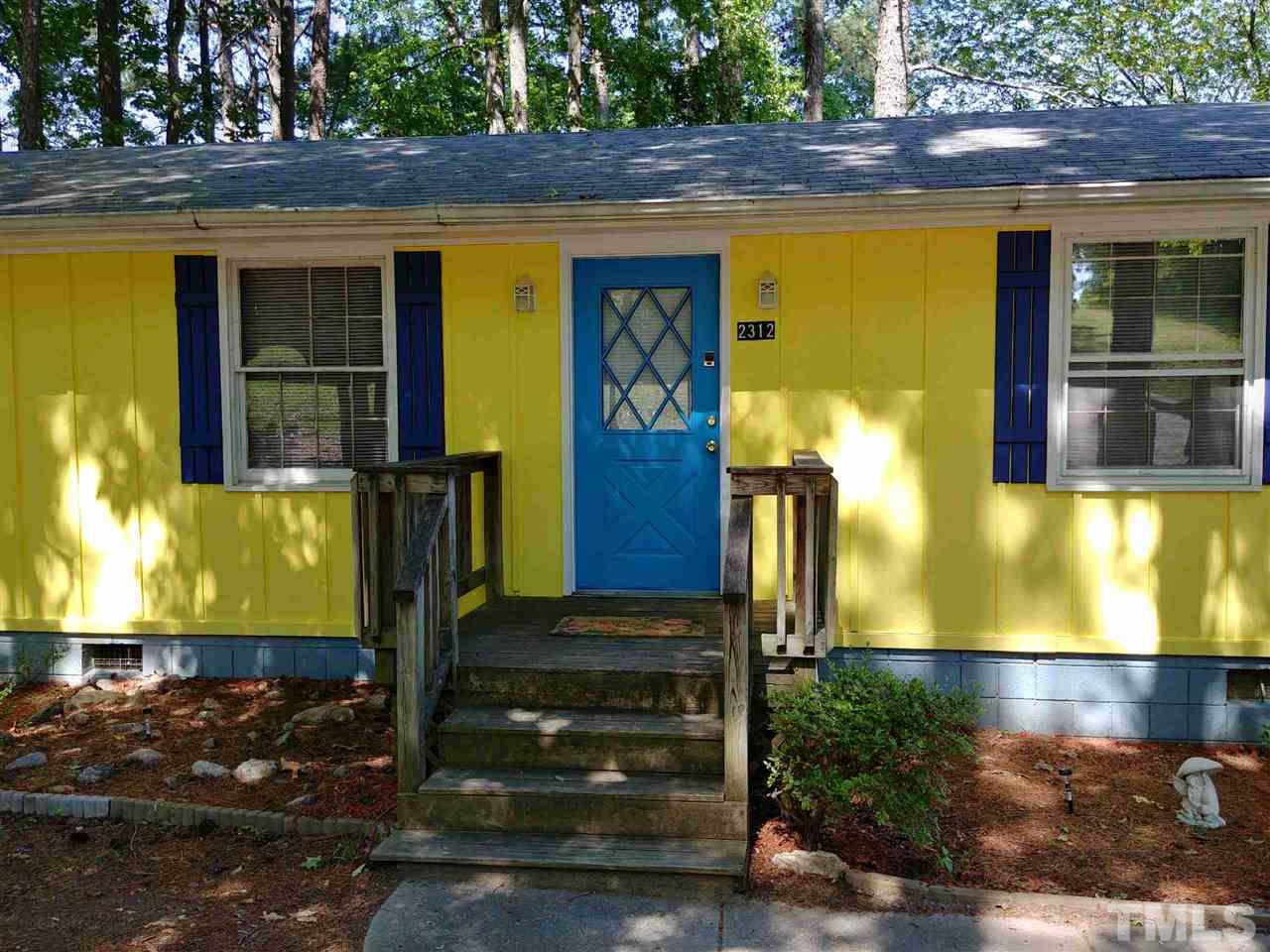 2312 Creech Road Raleigh, NC 27610 - Photo 2 of 11 a front view of a house with a yard