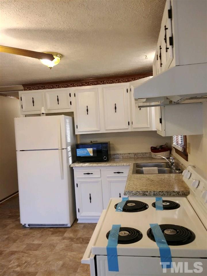 2312 Creech Road Raleigh, NC 27610 - Photo 5 of 11 a kitchen with a stove and a refrigerator