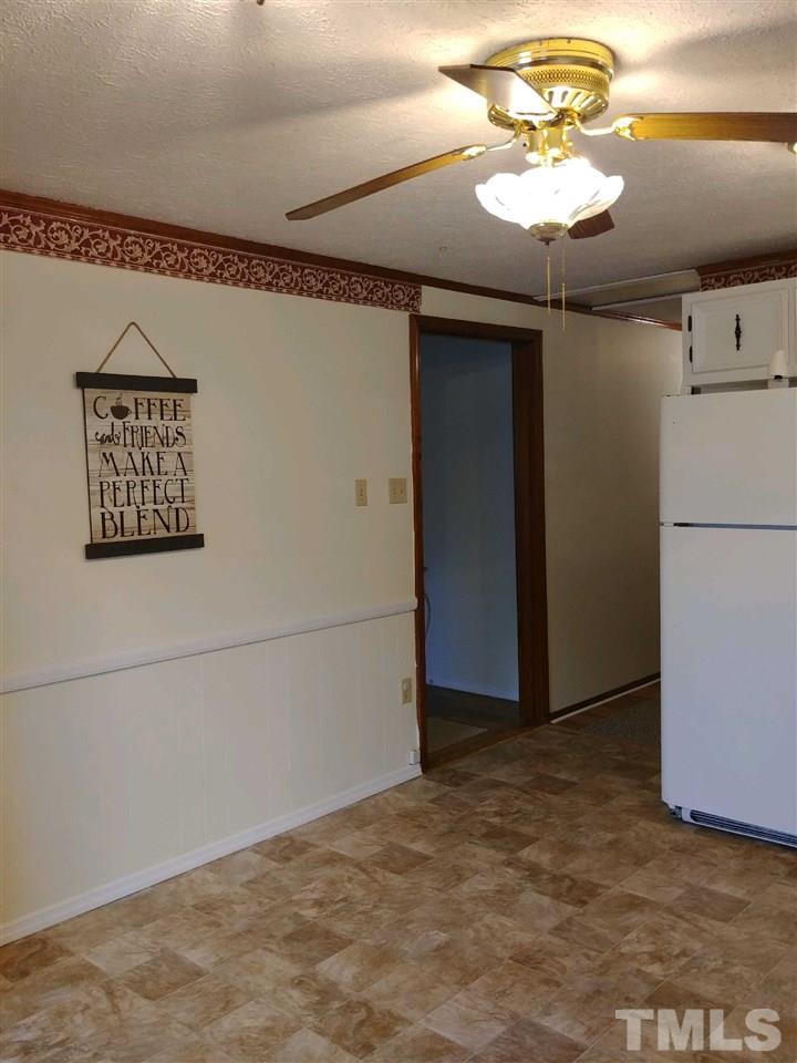 2312 Creech Road Raleigh, NC 27610 - Photo 7 of 11 a view of an empty room with a chandelier