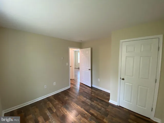 a view of an empty room and wooden floor