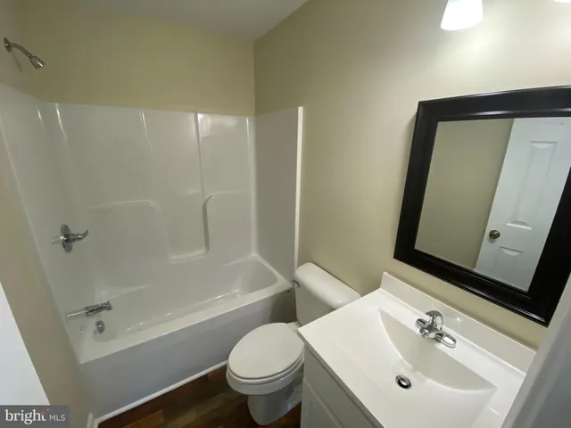 a bathroom with a sink a mirror and a toilet