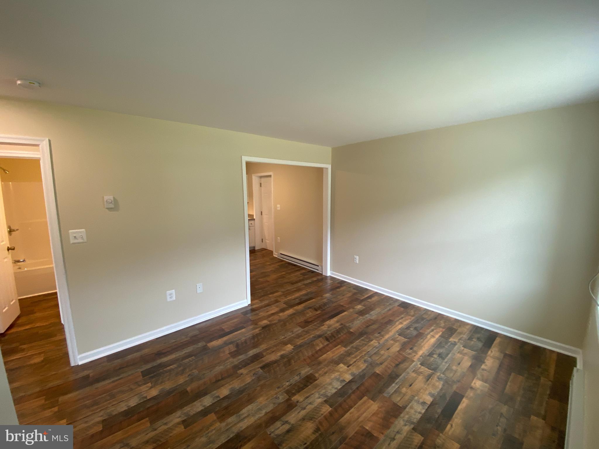 114 Loch Ln Drive, Unit 5 Louisa, VA 23093 - Photo 2 of 17 an empty room with wooden floor and entrance