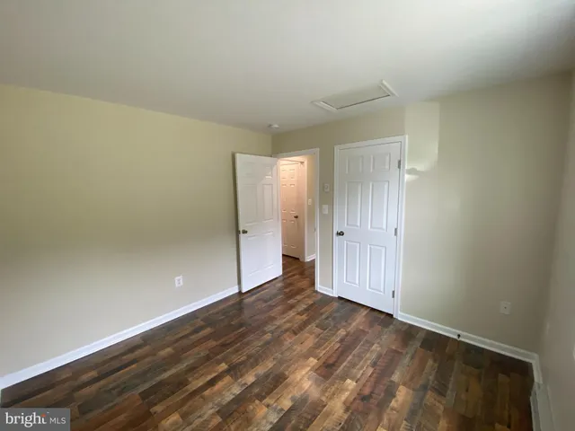 a view of an empty room and wooden floor