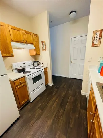 a kitchen with wooden floors and a stove