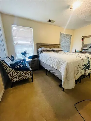 a bedroom with a bed and window