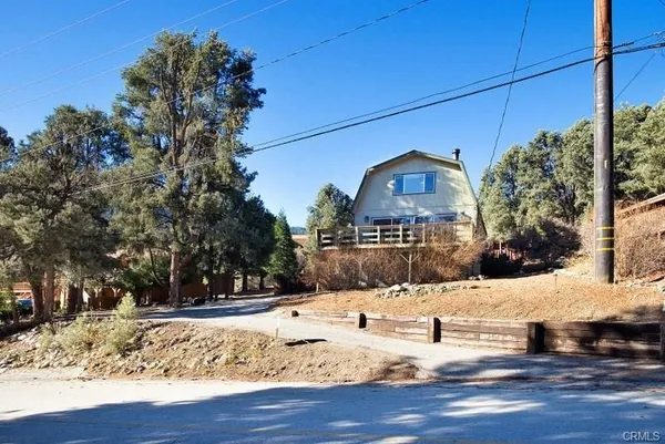 a view of a house with a yard covered in snow