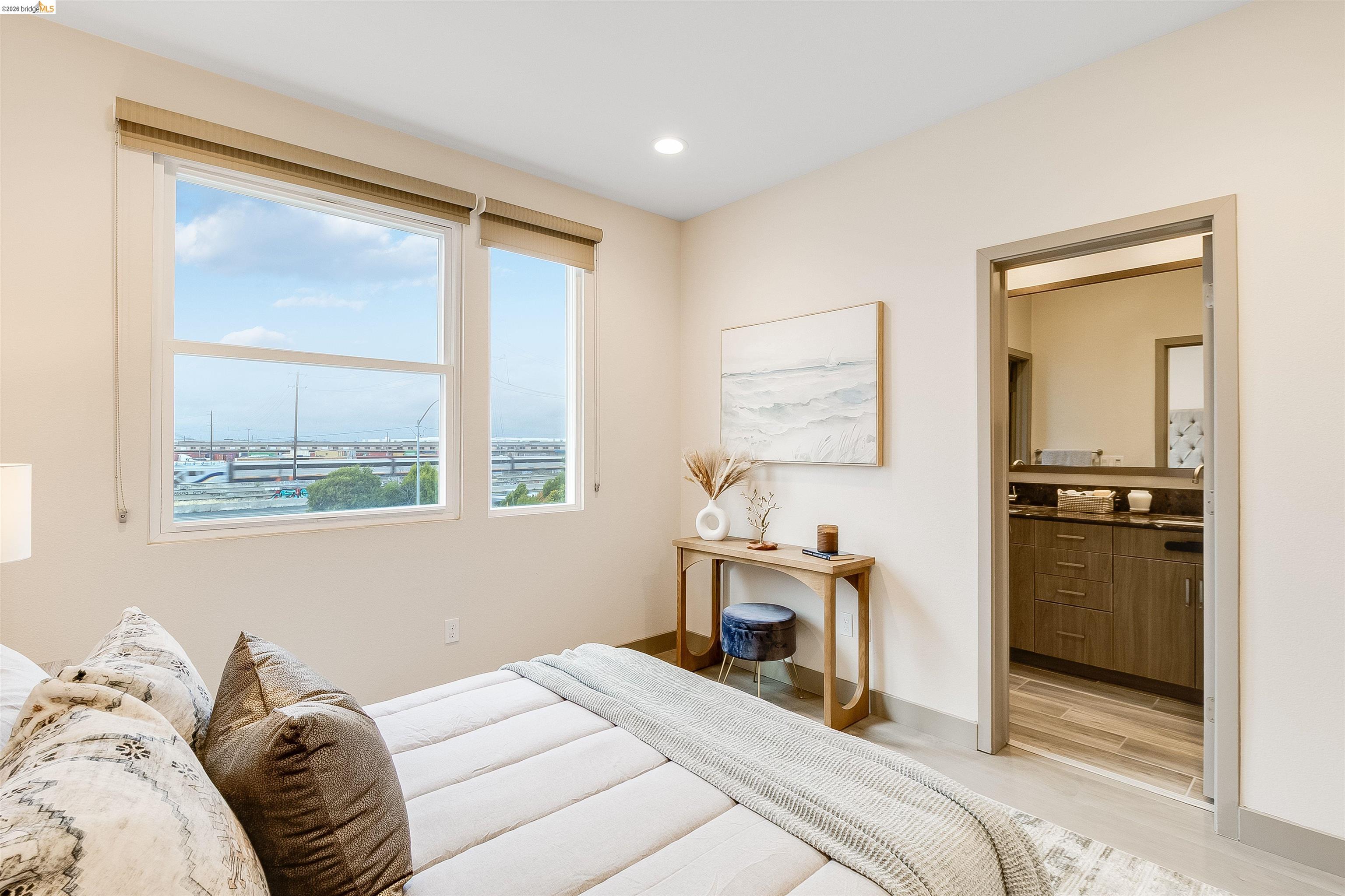 1357 Pullman Way Oakland, CA 94607 - Photo 24 of 37 Bright room featuring two large windows with roller shades, recessed ceiling lighting, and wood-finish flooring