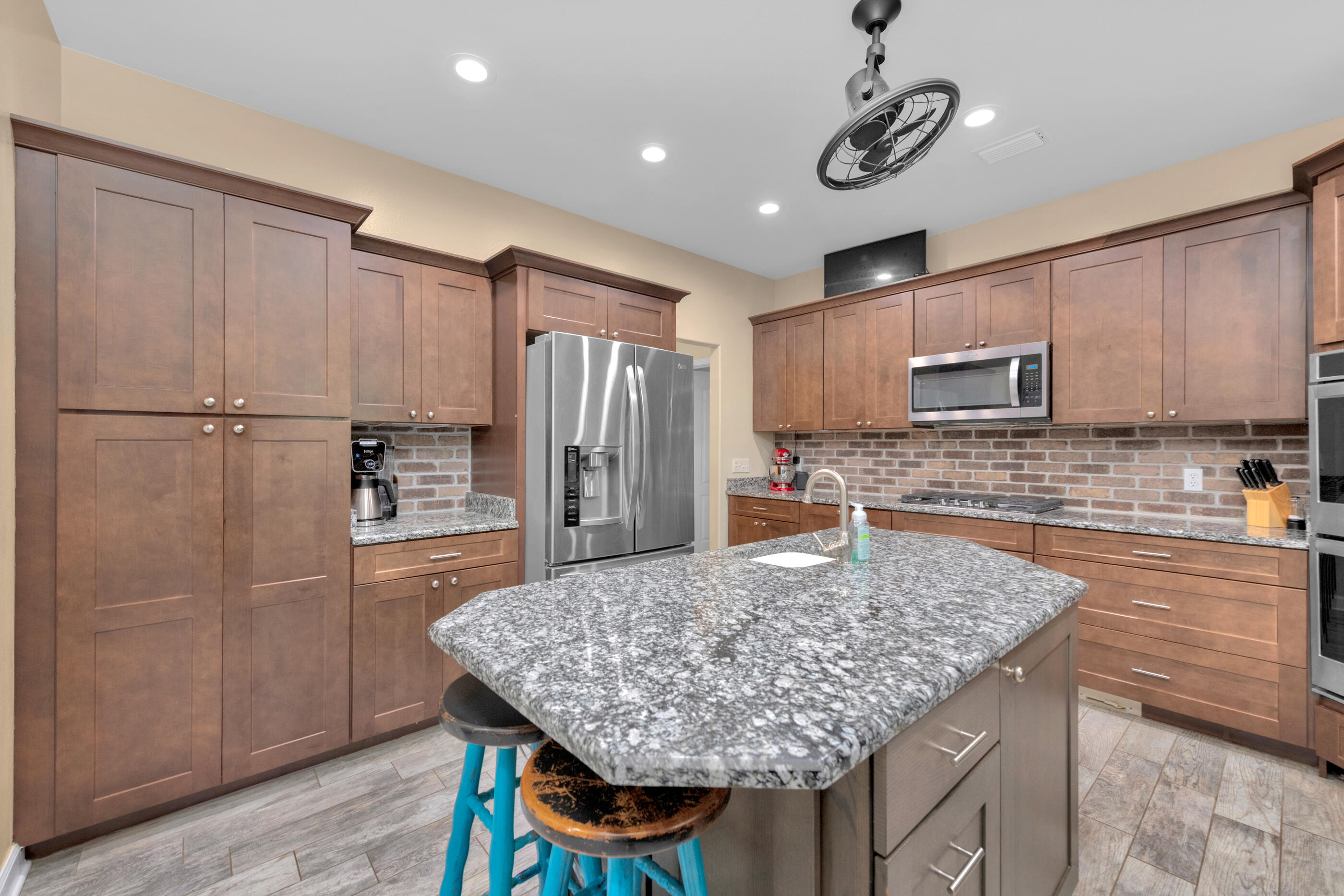 4475 Woodbridge Road Niceville, FL 32578 - Photo 11 of 49 a kitchen with stainless steel appliances granite countertop a refrigerator a stove and a sink
