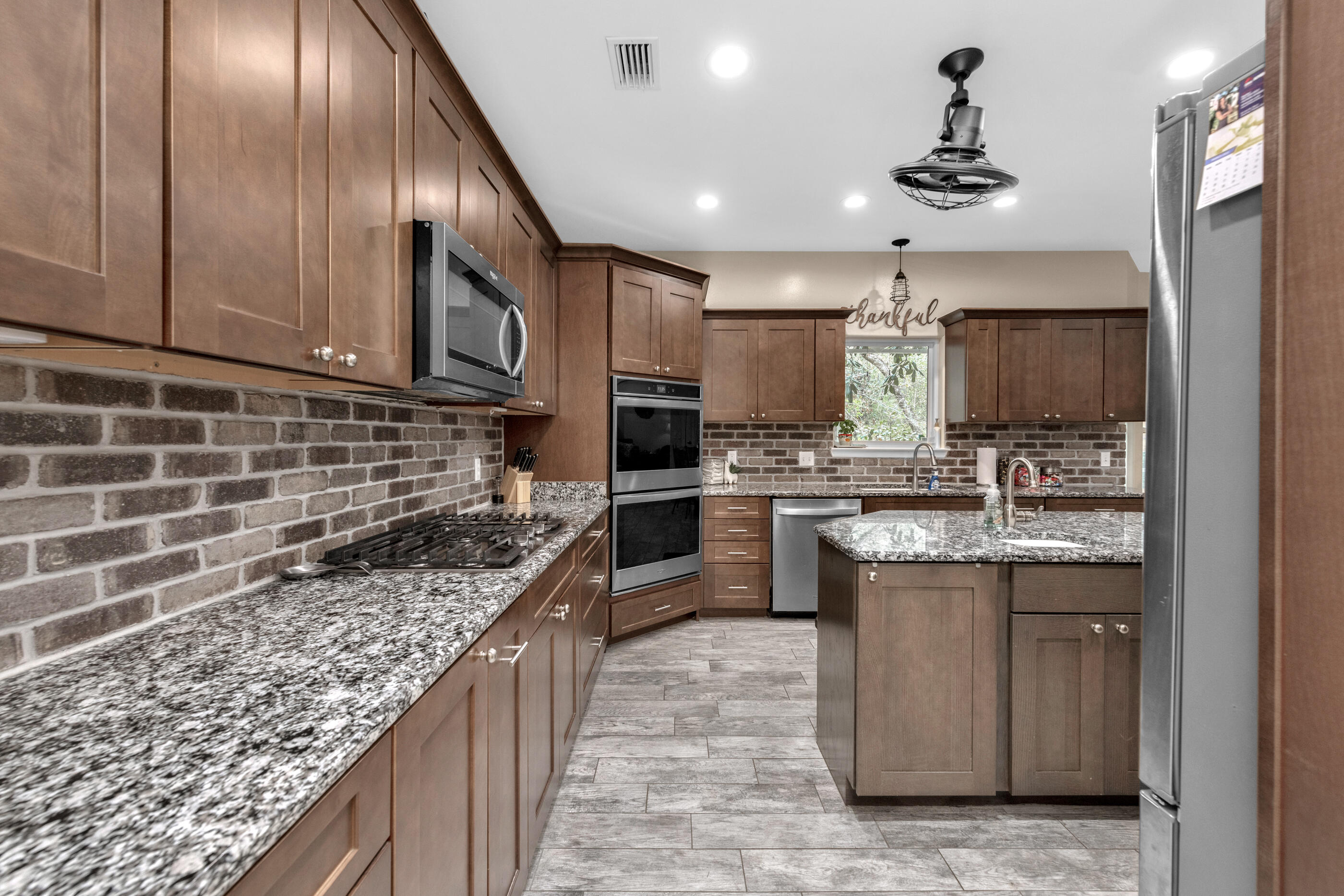 4475 Woodbridge Road Niceville, FL 32578 - Photo 12 of 49 a kitchen with stainless steel appliances granite countertop a sink stove and cabinets