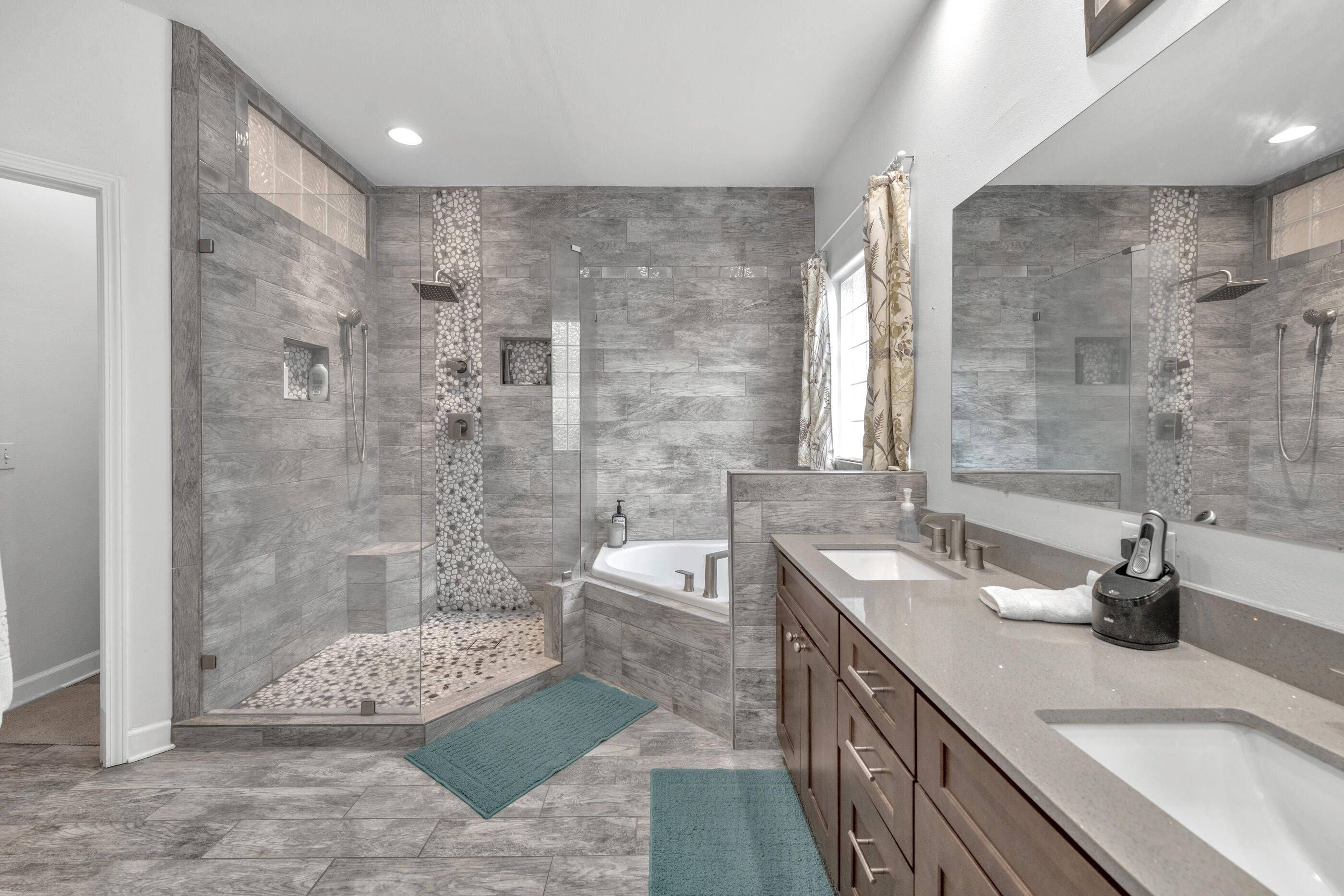 4475 Woodbridge Road Niceville, FL 32578 - Photo 26 of 49 a spacious bathroom with a granite countertop sink a toilet a mirror and shower