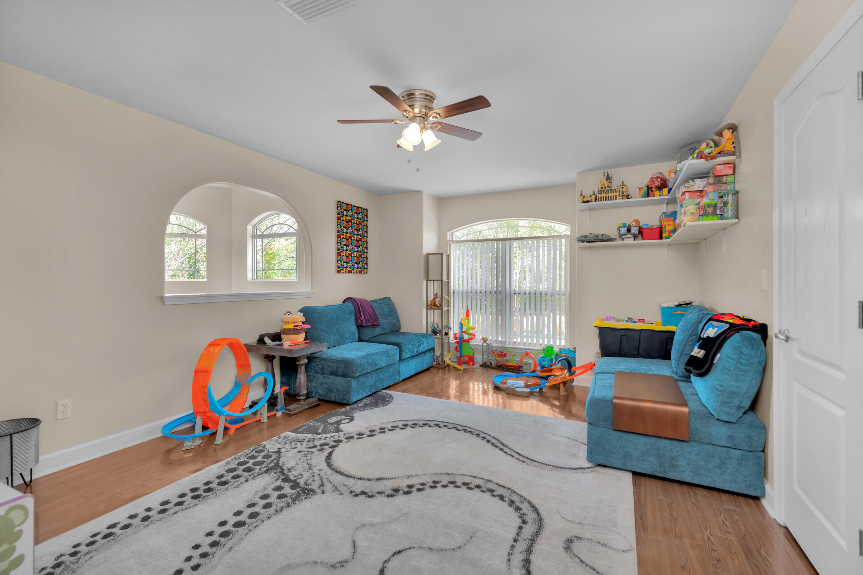 4475 Woodbridge Road Niceville, FL 32578 - Photo 30 of 49 a bedroom with furniture and a wooden floor