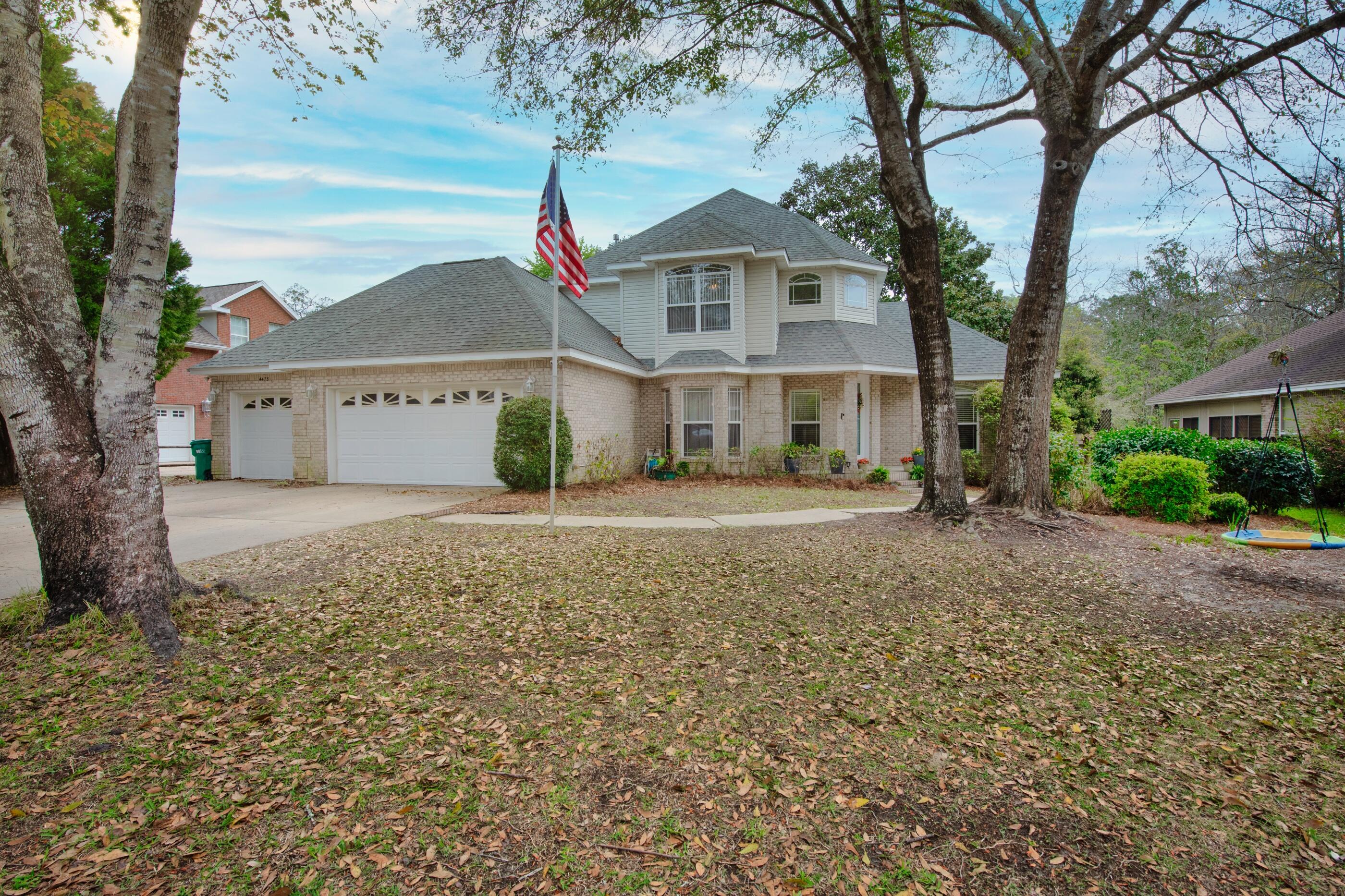 4475 Woodbridge Road Niceville, FL 32578 - Photo 3 of 49 a front view of a house with a yard