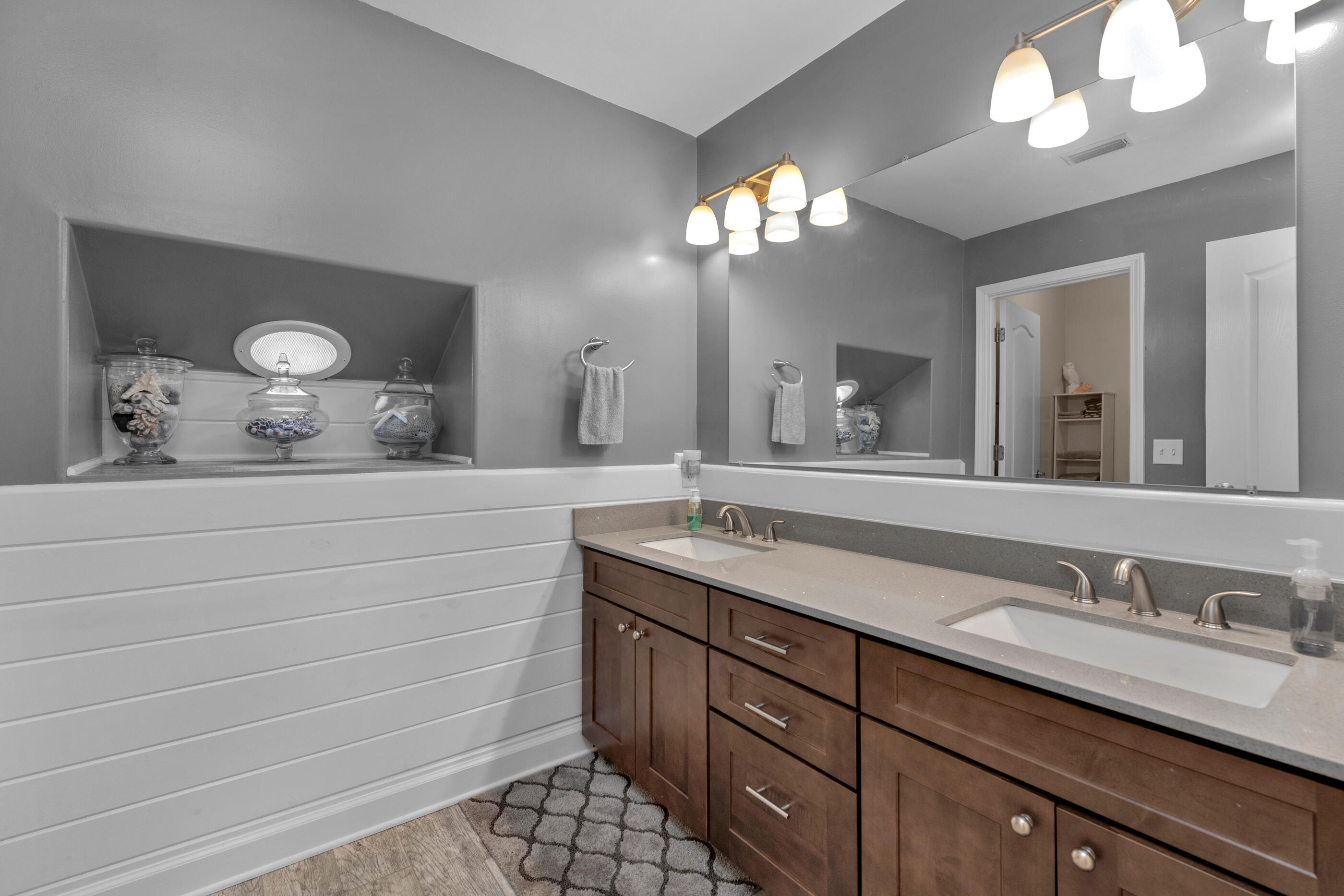4475 Woodbridge Road Niceville, FL 32578 - Photo 31 of 49 a bathroom with a granite countertop sink a light fixture and a mirror