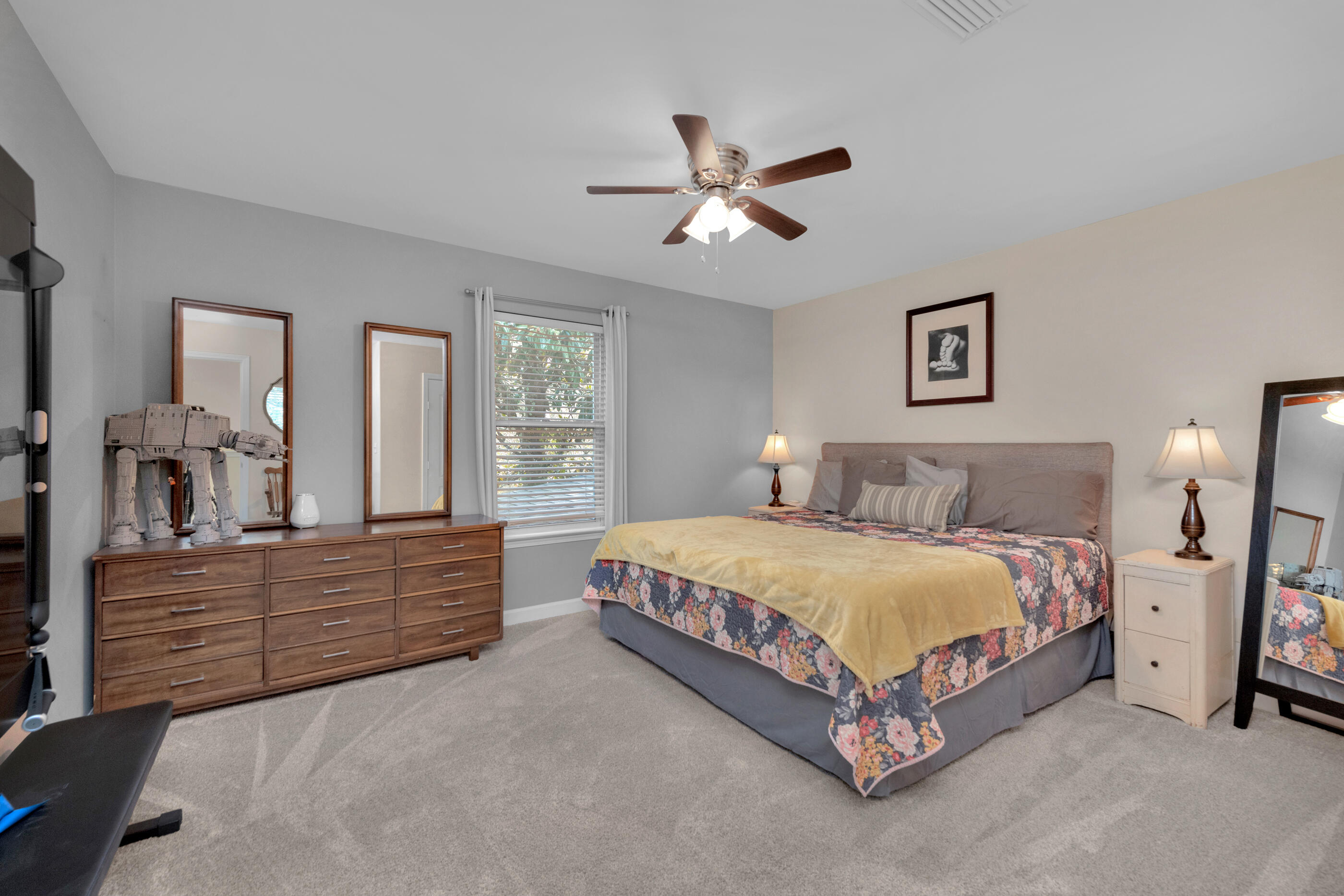 4475 Woodbridge Road Niceville, FL 32578 - Photo 35 of 49 a spacious bedroom with a bed and a chandelier