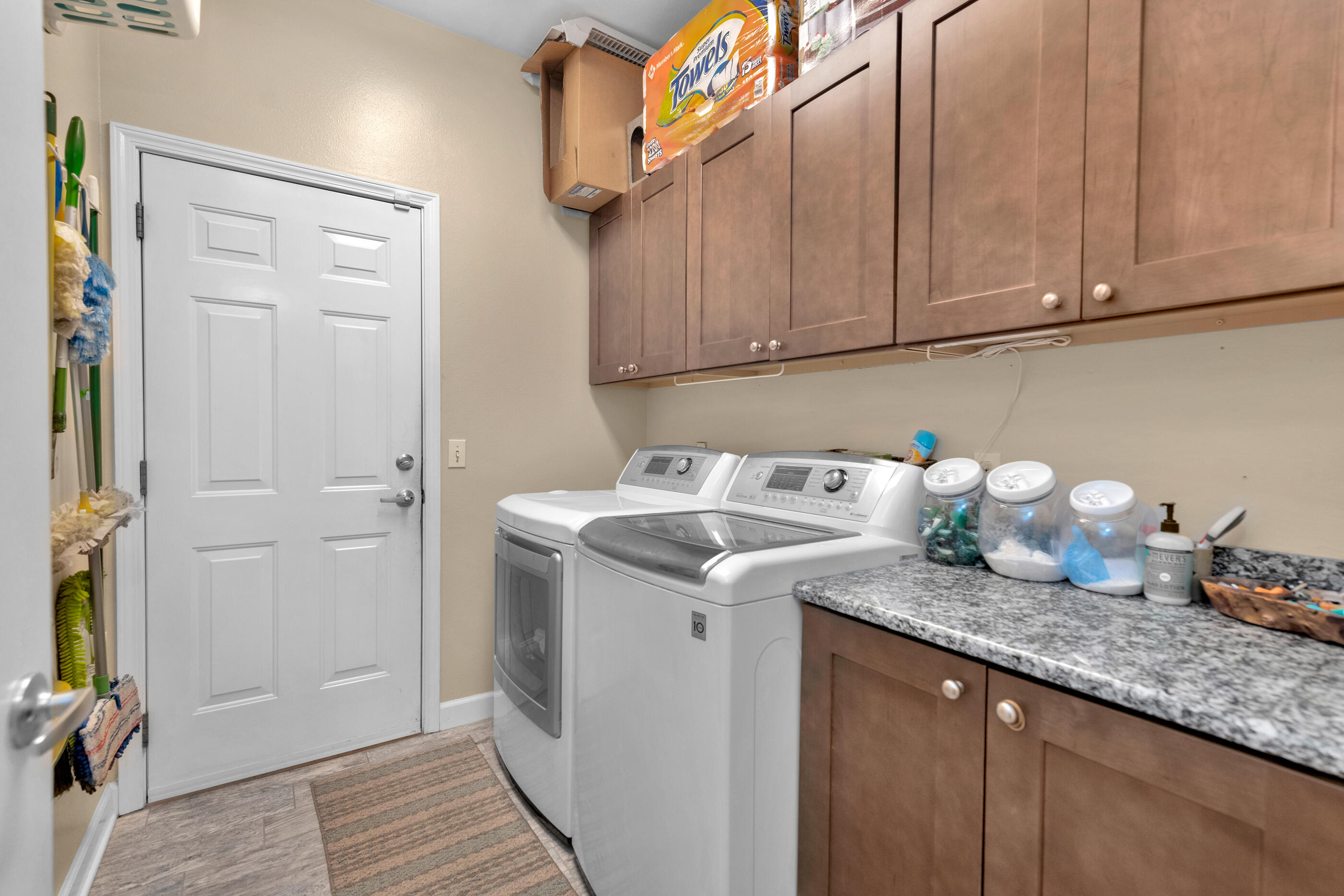 4475 Woodbridge Road Niceville, FL 32578 - Photo 37 of 49 a utility room with granite countertop cabinets washer and dryer