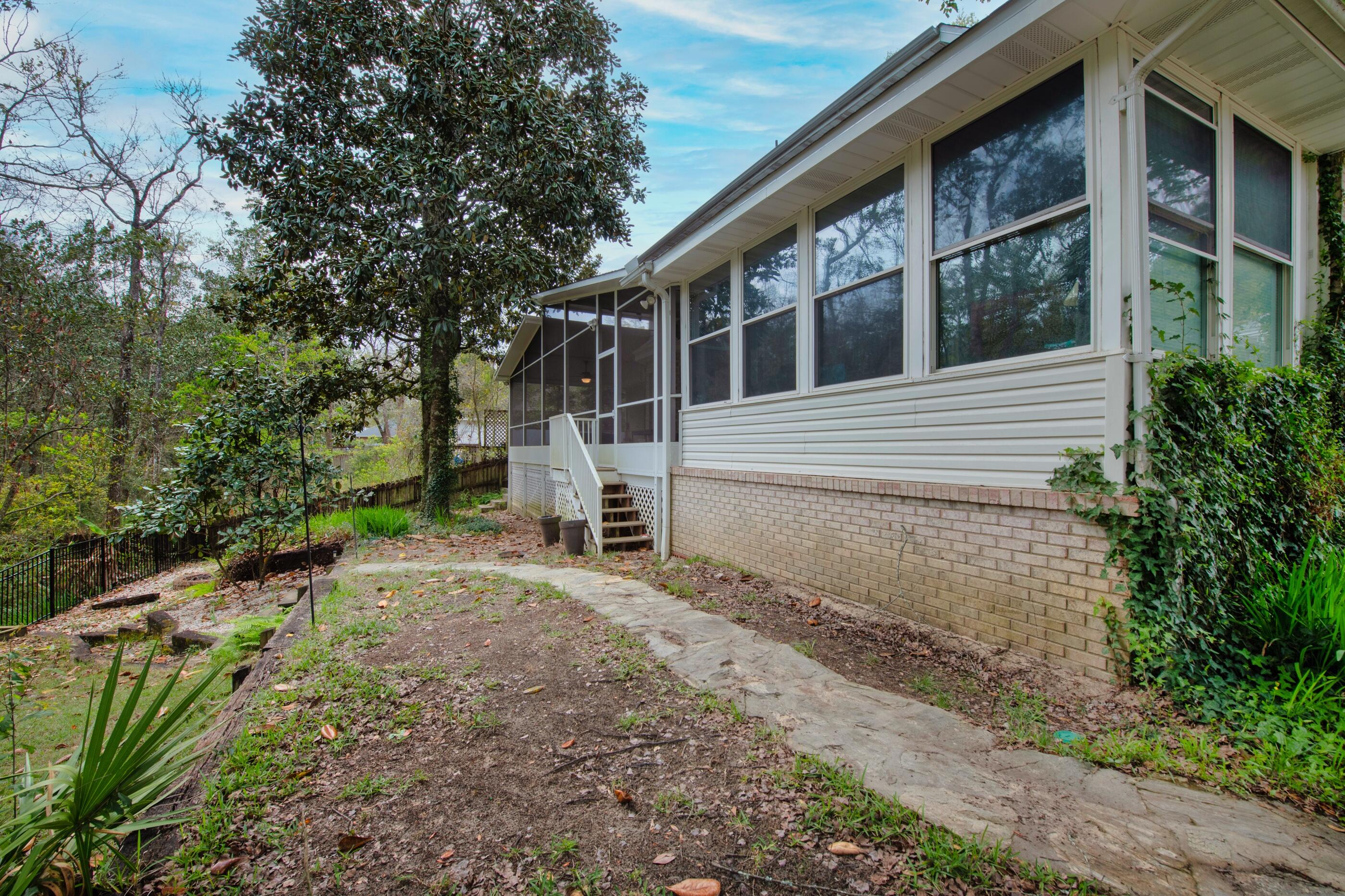 4475 Woodbridge Road Niceville, FL 32578 - Photo 45 of 49 a view of a house with a yard