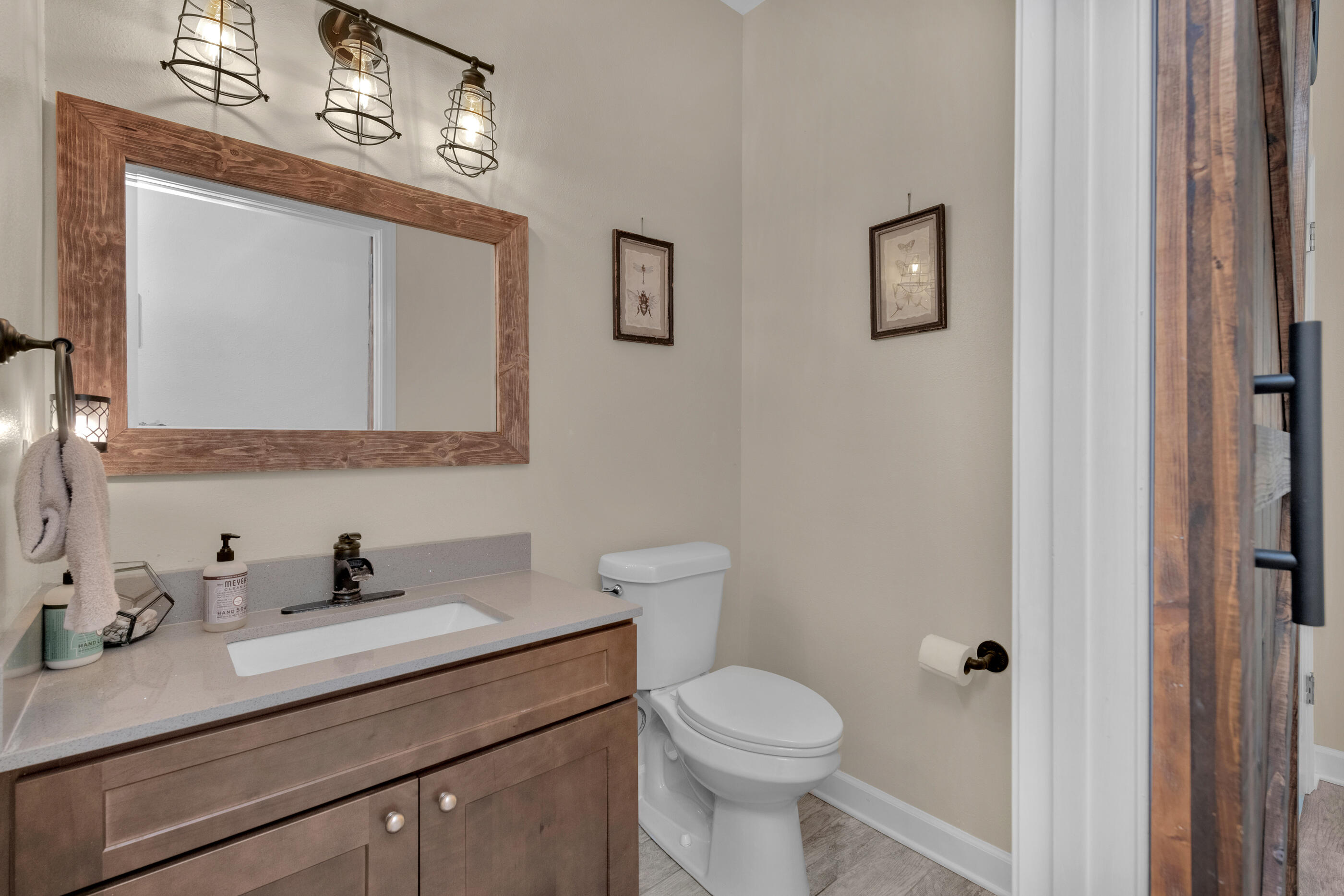 4475 Woodbridge Road Niceville, FL 32578 - Photo 9 of 49 a bathroom with a toilet a sink a vanity and mirror