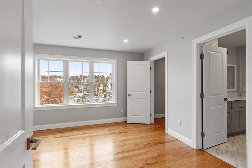 10 Windsor Street Worcester, MA 01605 - Photo 12 of 26 a view of an empty room with wooden floor and a window