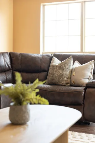 a kitchen with granite countertop a microwave a stove a sink a refrigerator and wooden floor