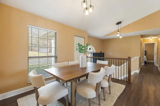 a kitchen with a table chairs cabinets and window