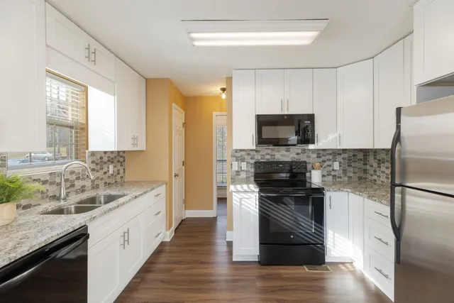 a bathroom with double sink and a mirror