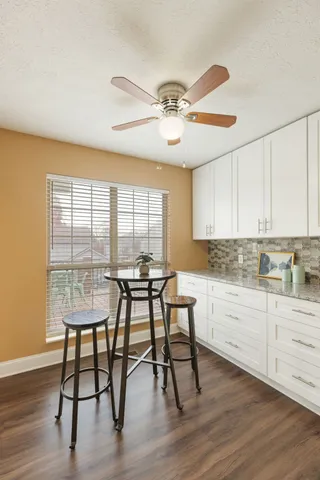 a bathroom with a granite countertop sink toilet and mirror