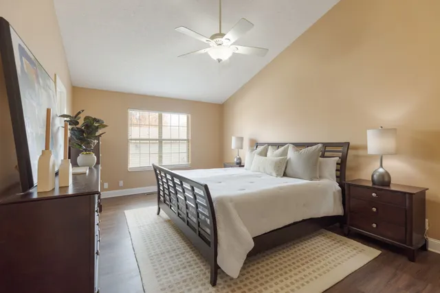 a bedroom with a bed and a mirror