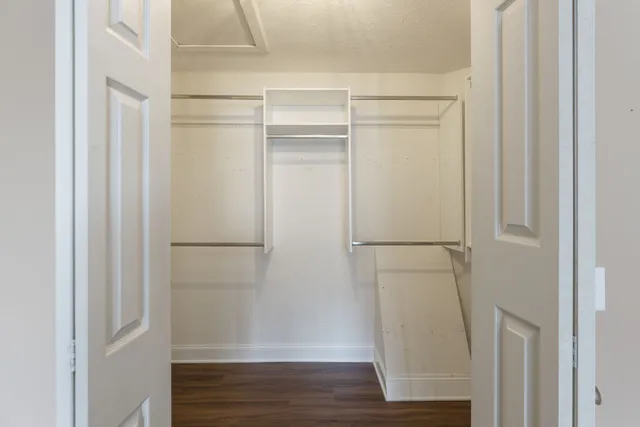 an empty room with wooden floor and closet
