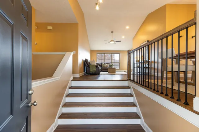 a living room with furniture a chandelier and a rug