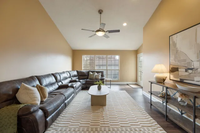 a living room with furniture and a chandelier