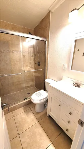 a bathroom with a toilet a sink and shower