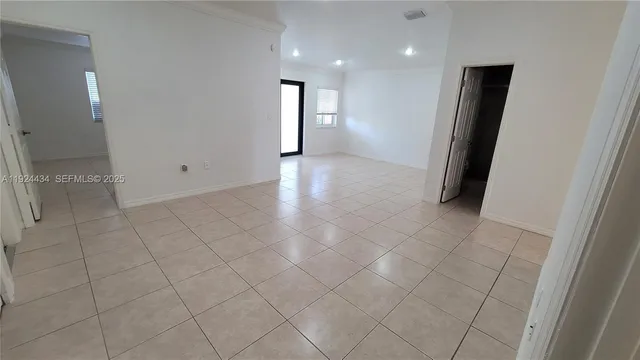 an empty room with wooden floor and mirror