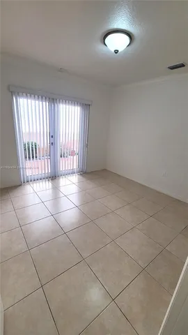a view of a livingroom with a tiles and a window