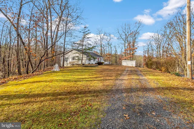 a view of a house with wooden fence