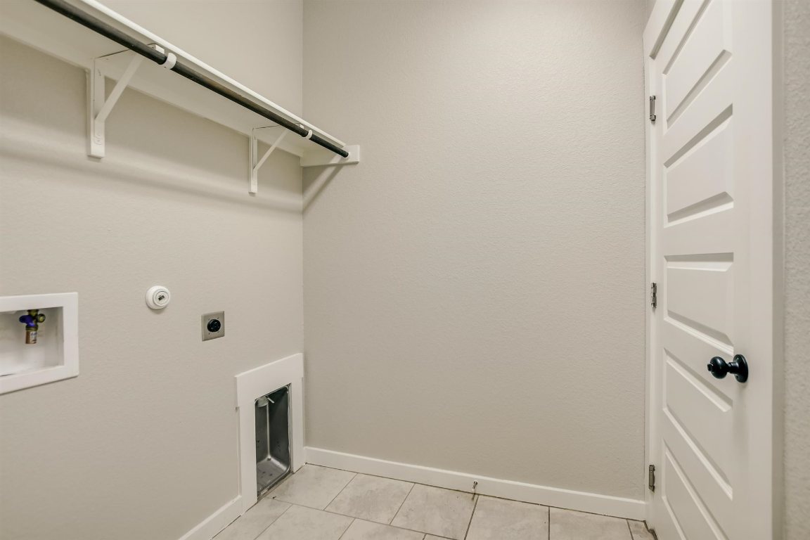 124 Ancellotta Way Leander, TX 78641 - Photo 11 of 20 Washroom featuring electric dryer hookup, hookup for a washing machine, and light tile patterned floors