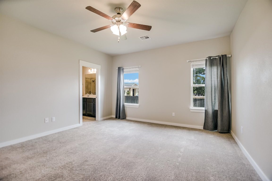 124 Ancellotta Way Leander, TX 78641 - Photo 12 of 20 Empty room with ceiling fan and light colored carpet