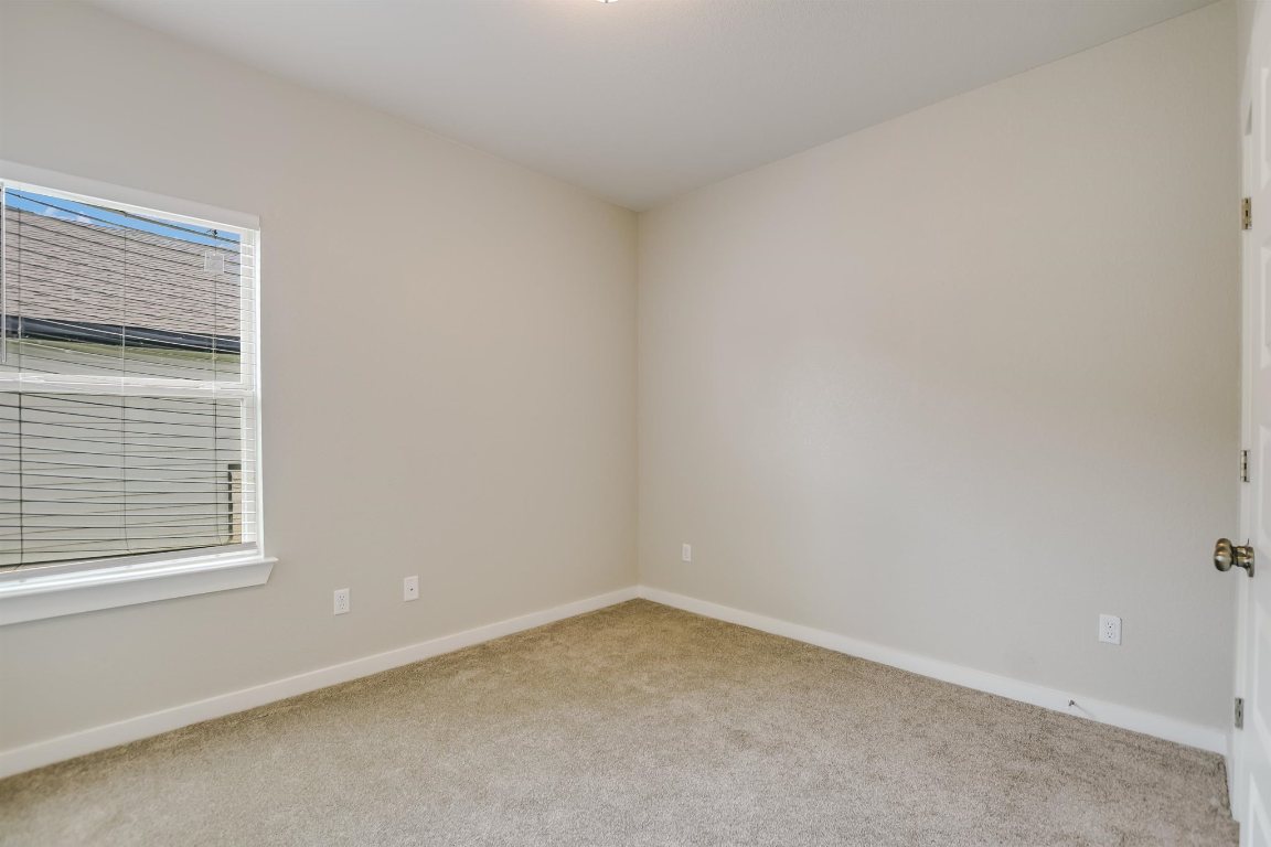 124 Ancellotta Way Leander, TX 78641 - Photo 16 of 20 Carpeted empty room featuring baseboards