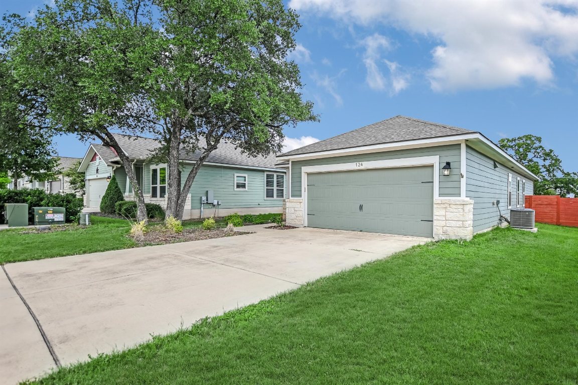 124 Ancellotta Way Leander, TX 78641 - Photo 2 of 20 Ranch-style home with driveway, a shingled roof, stone siding, and an attached garage