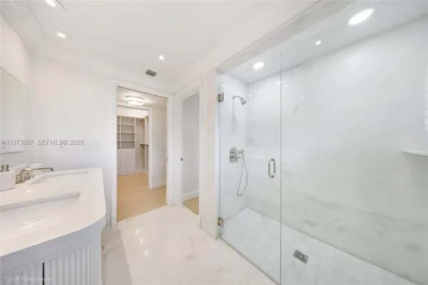 a bathroom with a shower sink and mirror