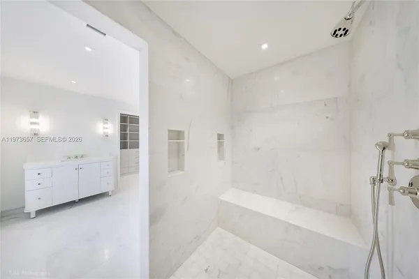 a bathroom with a bathtub and a shower